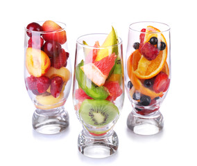 Fresh fruits salad in glasses isolated on white