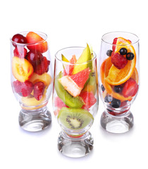 Fresh fruits salad in glasses isolated on white