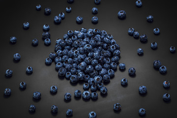 Wet blueberries on black slate