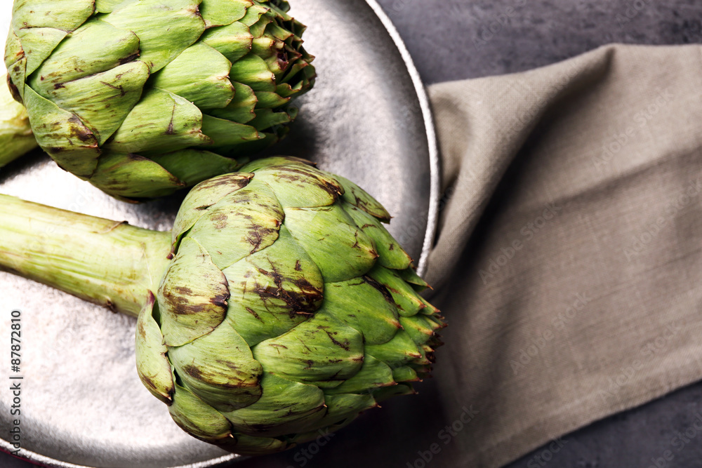 Sticker artichokes on color wooden background