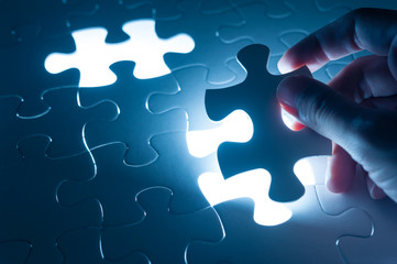 Hand insert jigsaw, conceptual image of business strategy, decis