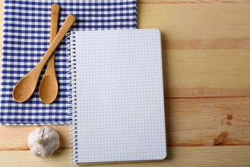 Open recipe book on wooden background