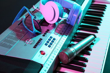 Obraz na płótnie Canvas Headphones with microphone on synthesizer close up