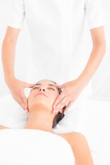 Fototapeta na wymiar Attractive woman getting a head massage 