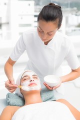 Attractive woman receiving treatment at spa center