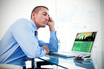 Fototapeta premium Composite image of tired businessman looking at his laptop