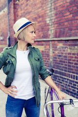 Hipster woman with vintage road bike in city