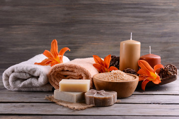 Beautiful spa composition with flowers on wooden table close up
