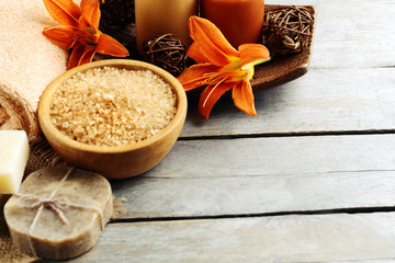 Beautiful spa composition with flowers on wooden table close up