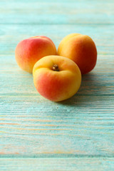 Ripe apricots on wooden table close up