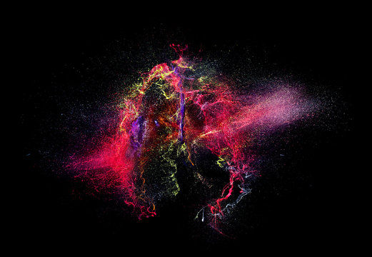high speed photography of an explosion of acrylic colors on a black background. nobody around. concept of art, strength, joy and creativity.