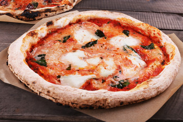 Delicious pizzas on wooden table, closeup