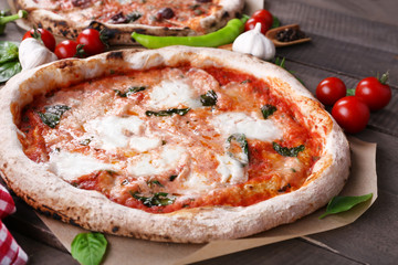 Delicious pizzas on wooden table, closeup