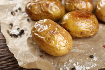 Baked spicy potatoes on parchment, closeup