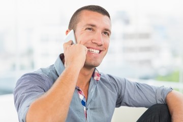 Smiling businessman laughing on the phone