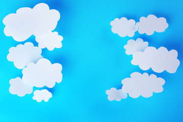 White paper clouds on blue background. Cloud computing concept.