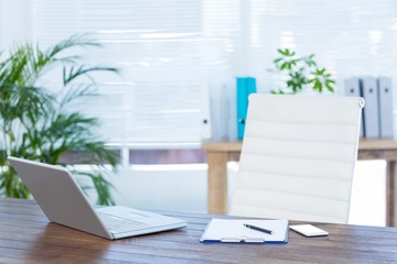 Business desk with laptop and notebook