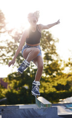 High jump on rollerblades in the skatepark