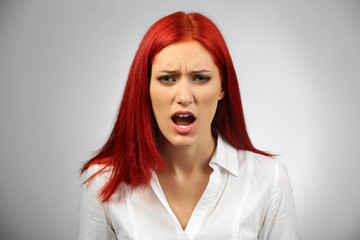 Beautiful young woman on gray background