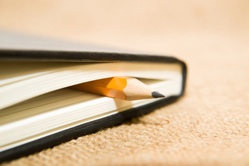 notebook and pencil on the old tissue