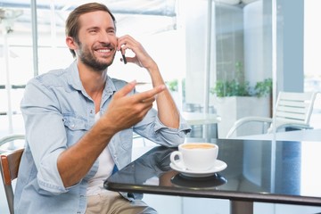 Young happy man talking on the phone