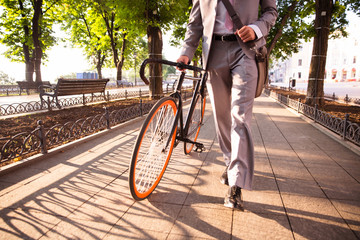 businessman walking with bicycle