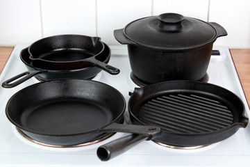 Seasoned cast iron cookware on electric stove - 87888420