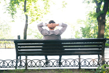 Businessman resting on the bench outdoors