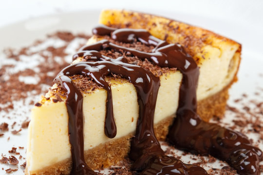 Cheesecake slice with melted and crushed chocolate