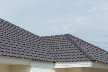 black tile roof on a new house © sutichak