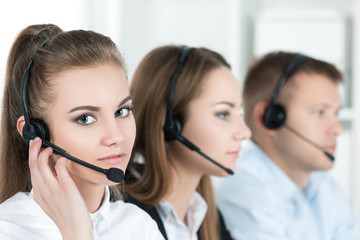 Portrait of call center worker accompanied by her team