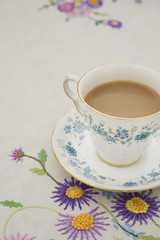 Obraz na płótnie Canvas Vintage tea cup,saucer and tablecloth