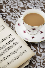 Vintage tea cup,saucer and Old Musical Score Sheets