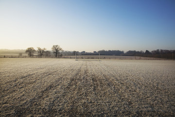 empty football pitch and goal on a frosty winter morning sunrise © jasoncoxphotography