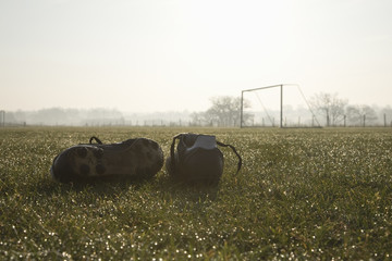 football boots on a empty football pitch