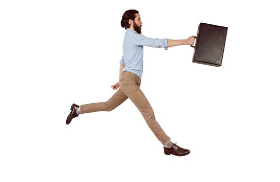 Handsome hipster leaping with briefcase