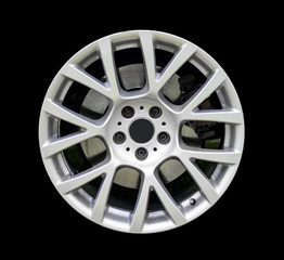 Sports car rim isolated on black background.