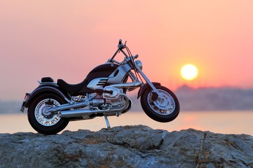 Motorcycle on the rocks in sunset and golden hours