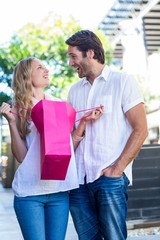 Smiling couple with shopping bags laughing