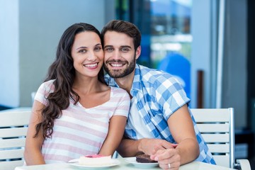  Young happy couple smiling at the camera