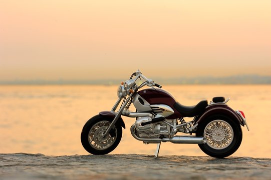 Fototapeta Motorcycle on the rocks in sunset and golden hours