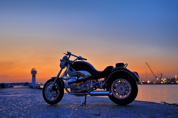 Obraz na płótnie Canvas Motorcycle on the rocks in sunset and golden hours
