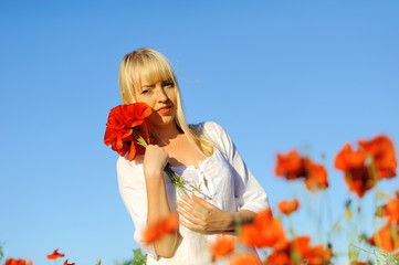 Young beautiful girl in the poppy