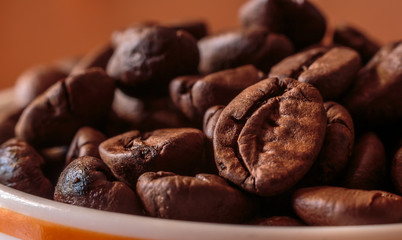Cup full of coffee beans, macro