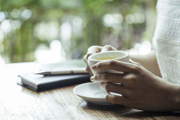 close up of woman holding a cup of tea 