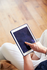 Close Up Of Woman Using Digital Tablet At Home