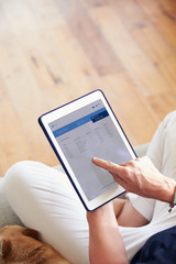 Woman Looking At Banking App On Digital Tablet