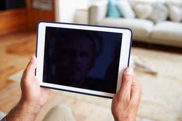Close Up Of Man Using Digital Tablet At Home
