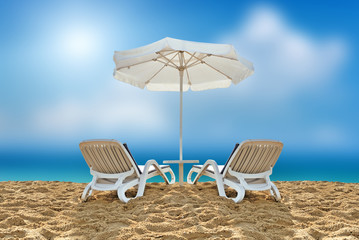 Beach chair and white umbrella on beach