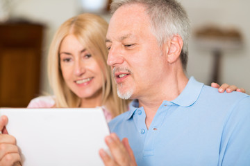 Mature couple using a digital tablet
